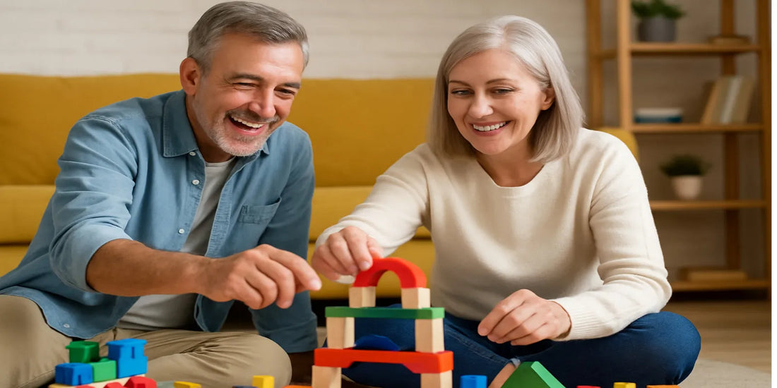 Smiling senior couple in their 50s playing with colorful wooden building blocks together in a cozy, bright living room.